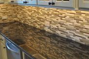 Under cabinet lighting help the chef see their work space easier and show off this elegant backsplash