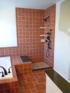 Check out this shower, featuring custom tile work, granite accents, and a beautiful shower base