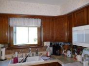 The kitchen, before Drumm Design Remodel, featured a soffit above the cabinets that did not quite follow the cabinet lines for sure