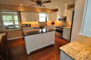 The view of the kitchen from the refrigerator side of the kitchen