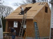 Plywood sheets going up on the roof