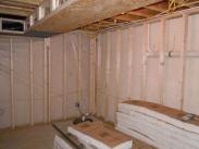 Another view of the framing and insulation, plus Drumm Design Remodel adds a vapor barrier to make your basement more energy efficient