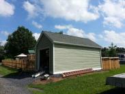 The exterior of the shed with new siding and a lot more space for family storage