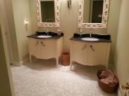 Double vanities simply did not provide enough storage space and the mirrors made the room feel smaller