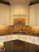 A view of the custom tile backsplash and range hood by Drumm Design Remodel