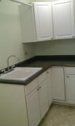 The laundry room featured a hanging rack above the sink